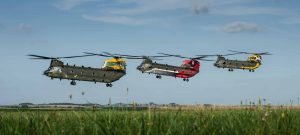 Pictured are a special formation of Chinooks from 18,27 & 28 Sqn, part of their 100th anniversary celebrations. On Wednesday 14 September a very special formation left RAF Odiham bound for the south coast of England but tactical camouflage was not on the agenda! In the past 18 months three Chinook aircraft have been painted to celebrate the 100th anniversaries of 18(B) and 27 Squadron from RAF Odiham and 28 Squadron from RAF Benson. With the first of the helicopters expected to be returned to standard operational markings in the near future this opportunity was integrated in to a formation training sortie which tested the crews&Otilde; ability to plan and execute some very unique tasks. With it being so complex the mission was, unusually, briefed the day prior to launch and each crew walked through the various maneouvres in the hangar, in what is colloquially known as a &Ocirc;rock drill.&Otilde; At the hour they walked for their aircraft each member had a firm grasp of the planned movements which enabled them to focus on maintaining strict safety margins. The day itself was only the end of a long road though, with preparation having begun over 6 months ago. Operational restraints cancelled the first planned date in June and the only other window where all three aircraft were available concurrently was identified as being this week. RAF Odiham&Otilde;s dedicated and professional engineering teams were therefore faced with generating three very specific airframes to complete this sortie whilst concurrently deploying multiple others to support exercises in Sweden and onboard HMS Ocean and providing manpower to flying detachments in the United States and elsewhere. They succeeded and the results of their efforts are clearly seen.The Serco team who painted the Chinooks at Odiham, each in the space of two intense weeks, were invited to see the three lined up on the dispersal together for what may be the first and only time &ETH; a moment they had waited a long time to see. As for the